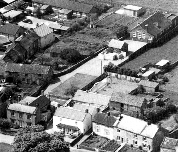 aerial photograph showing the schoolmaster's house with the schoolroom behind, and the later separate school building  